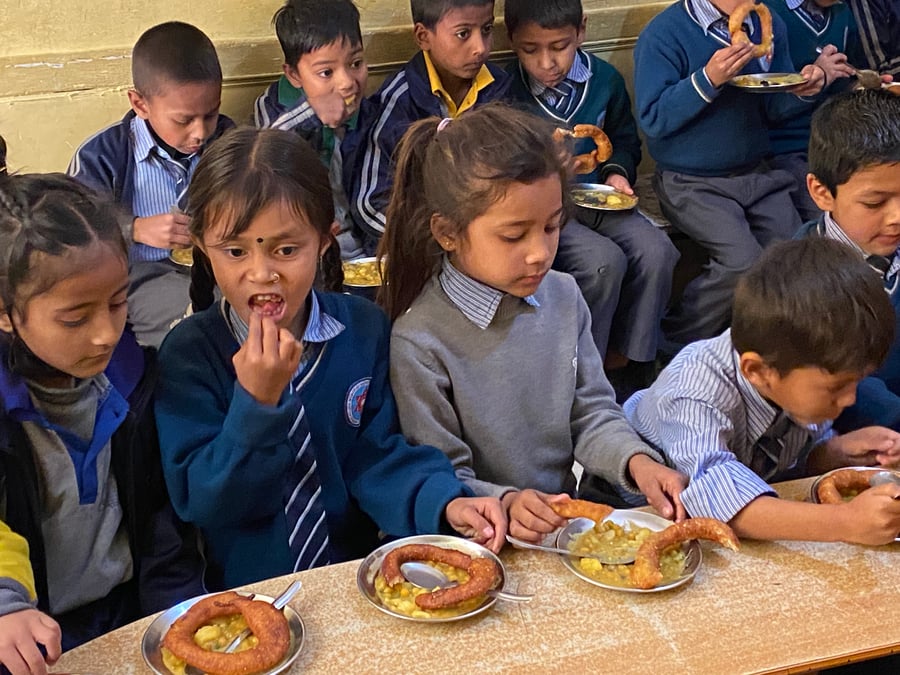 Students at Vijaya Memorial Secondary School in Dillibazar, Kathmandu eating their midday meal.