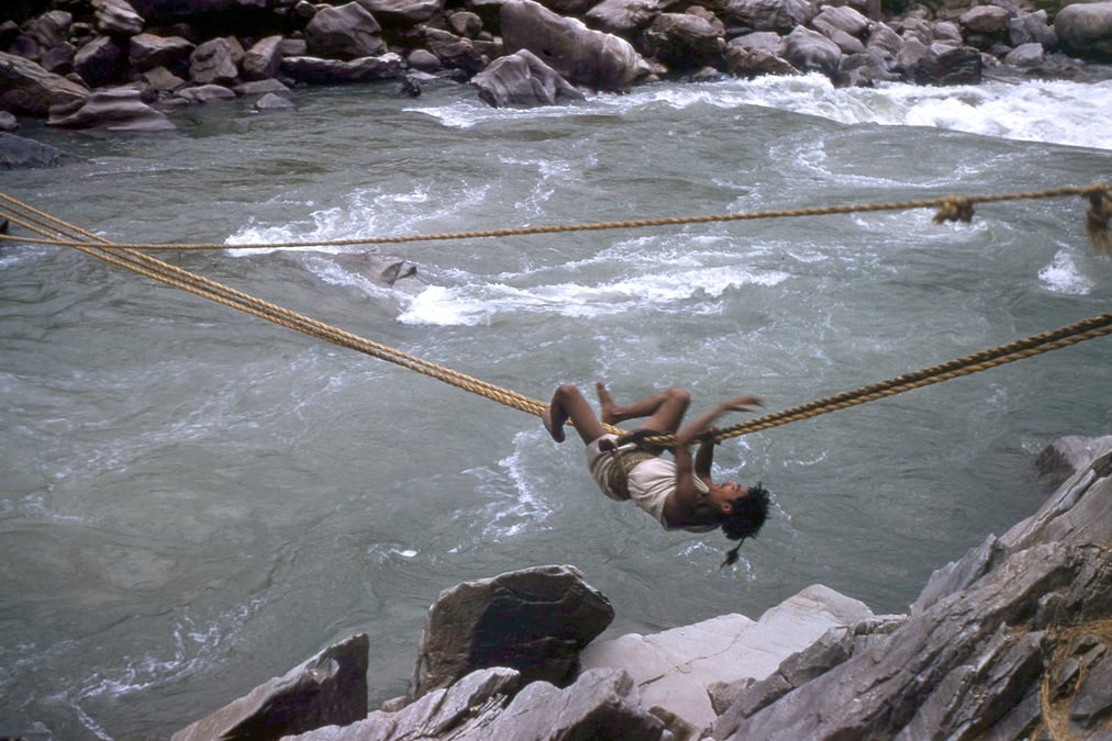 Man making a perilous crossing over the Seti River. All photos: TONI HAGEN