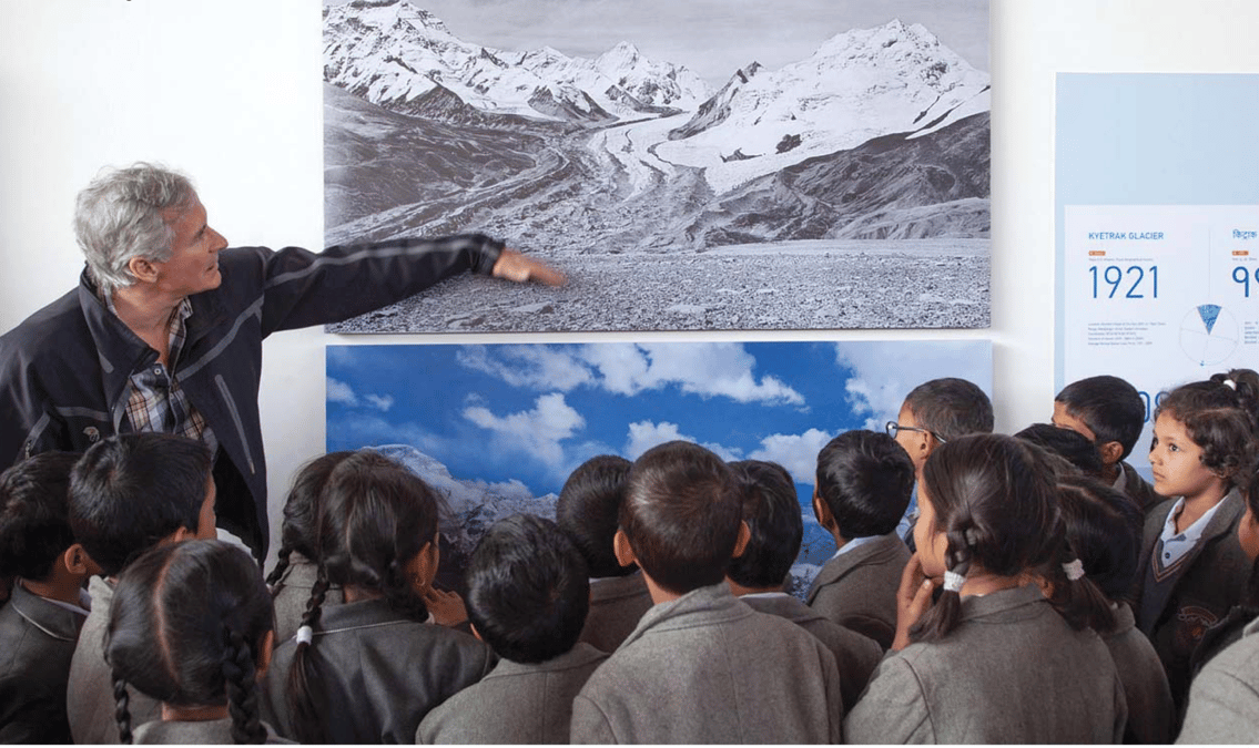 David Breashears at the Climate+Change exhibition in 2014 in Kathmandu, explaining his photographs to Nepali students. Photo: Climate+Change