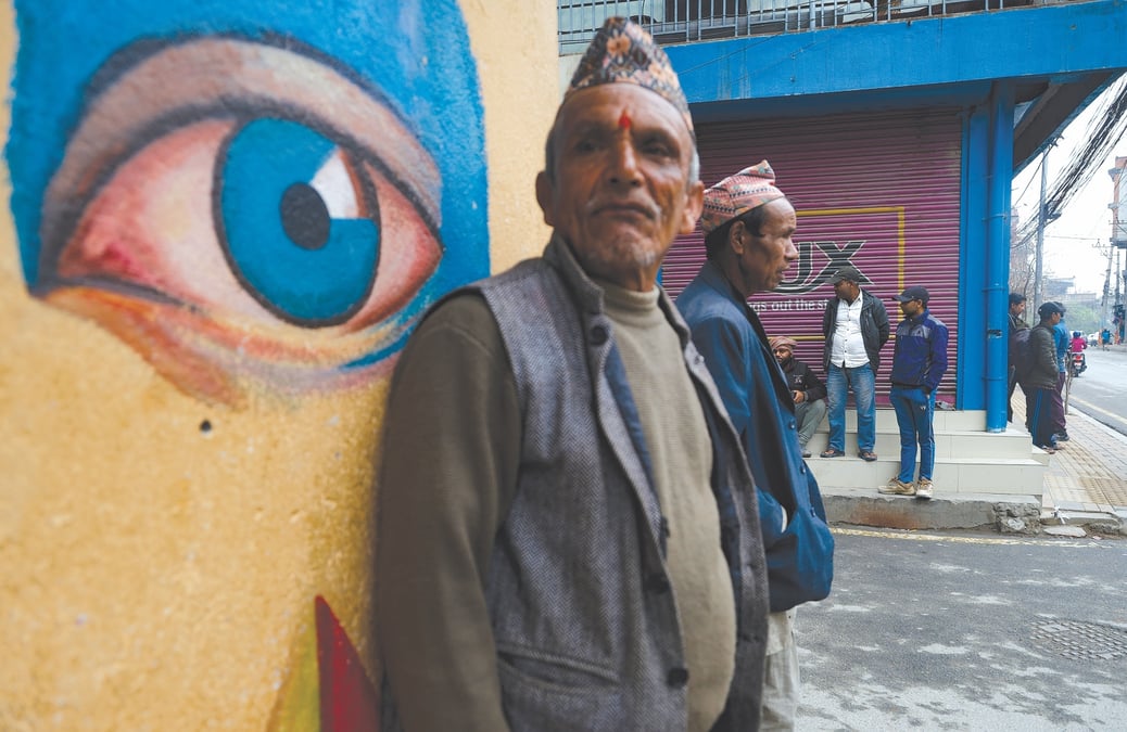 ON THE LOOKOUT: A day labourer waiting to be hired at Chakrapath Labour Chok in Kathmandu this week. Photo: GOPEN RAI