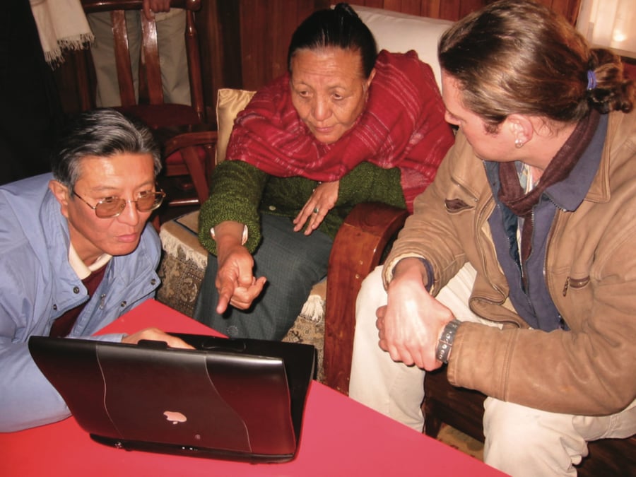 (From left) The late Khendzong Yapla (Secretary to the Government of Sikkim and local cultural historian), his late mother and Mark Turin viewing Williamson's 1930s footage of Sikkim, in Gangtok, Sikkim, India. Photo by Sara Shneiderman, January 2003.