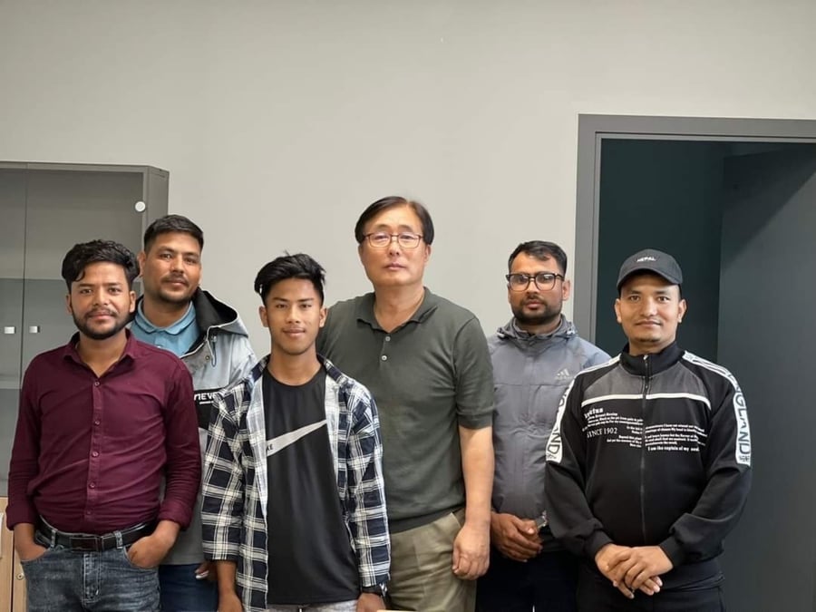 MEATY JOB: Nepali guest workers with Jonga Sun (centre, left) at his livestock farm in Korea.