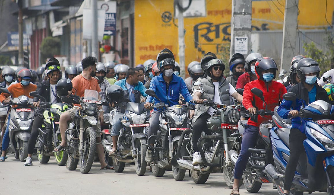 A long cue of motorcycles in Kathmandu waiting to refuel. Photo: AMIT MACHAMASI