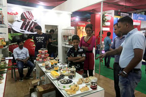 People stand around a food stall during the Food & Beverage and Hospitality event held at Bhrikutimandap, Kathmandu on Saturday.