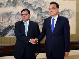 Deputy Prime Minister Krishna Bahadur Mahara shakes hands with Chinese Premier Li Keqiang in Beijing on Wednesday.