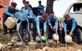 Nepal Police officers destroy illegal homemade liquor in Kathmandu on Thursday. The police seized a total of 900 bottles of homemade liquor bearing labels of genuine liquor companies from various restaurants and hotels.