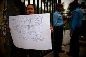 Youth protest against the use of cement in the reconstruction of Rani Pokhari, a 17th-century heritage site destroyed by last year's earthquake, in Kathmandu on Wednesday.