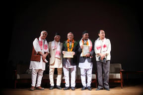 Lil Bahadur Chettri (third, left) and Ram Lal Joshi (second, right) on stage after receiving this year's Jagadamba Shree Puraskar and Madan Literature Prize respectively in Patan on Sunday.