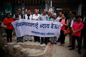 Rights activists stage a sit-in outside Bir Hospital, Kathmandu on Tuesday demanding justice for Ganga Maya Adhikari, who has been on a prolonged hunger strike to put pressure on the government to arrest her son's murderers. She refused saline last week, and was admitted to the Bir Hospital ICU on Tuesday.