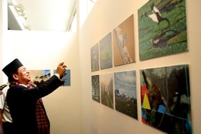 Deputy President Nanda Kishor Pun takes a picture during a photo exhibition organised by the Photojournalist Club at Nepal Art Council, Babarmahal on Monday.