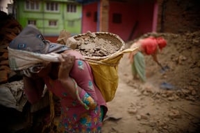 Bimala Tamang, 39 of Okhaldhunga works at a construction site to rebuild a house destroyed by last year's earthquake on Sunday.
