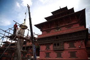 Volunteers from University of Applied Arts, Vienna in collaboration with Kathmandu Valley Preservation Trust reinstall the fallen statue of Yoga Narendra Malla at Patan Durbar Square on Friday.