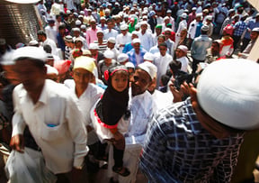 A man poses with his daughter inside Kashmiri Masjid, Kathmandu on the day of Eid al-Fitr on Thursday.