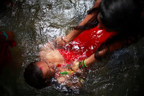 A Hindu devotee takes a holy dip in the Bagmati River during the Bol Bom pilgrimage at Sundarijal on Monday.