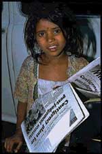 Children sell tabloids to make ends meet