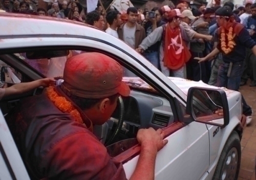 CROWD CONTROL: Maoist supporters form a human chain around the rally truck to control the huge crowd gathered at Patan.