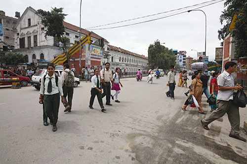 SPOT THE DIFFERENCE: Pedestrians cross the road at Bhotahity on Tuesday, where the overhead bridge has been dismantled for repairs.