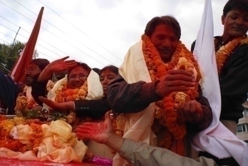 RED ALL OVER: Maoist candidates Raj Kaji Maharjan and Pampha Bhusal who won Lalitpur 2 and 3 go around Patan on the back of a truck with a procession of ecstatic followers.