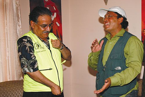 PUTTING IT ON: Maoist Chairman Pushpa Kamal Dahal dons a photojournalist's vest after meeting with members of the National Forum of Photo Journalists at his residence on Tuesday. The Forum discussed the attacks on photojournalists by Maoist party members during protest programs.
