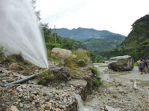 DANGEROUS FALL: A gigantic stone toppled down the hills on the Goleshwor-Beni highway, damaging a drinking water pipe and obstructing traffic. A team from the Nepal Army blasted the stone to remove it from the road.