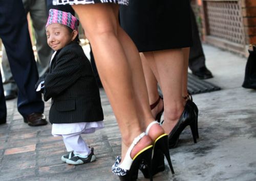 TALL AMBITIONS: Nepal's shortest man Khagendra Thapa Magar (Ambassador for NTY 2011) prepares to pose with Miss Nepal 2010 winners at a press meet organized by NTB on Friday.