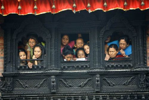WINDOW SEATS: Locals at Basantapur Darbar Square observe the festivities below on the last day of Indra Jatra on Monday.