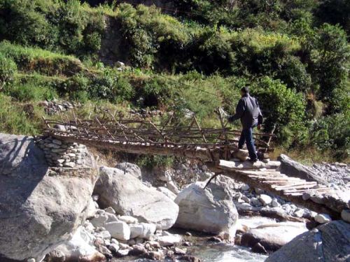 DAGEROUS CROSSING: A make-shift wooden bridge over Mailung rivulet links Dada villiage and Haku village in Rasuwa. The suspension bridge over the rivulet was destroyed by a flood 10 years ago.