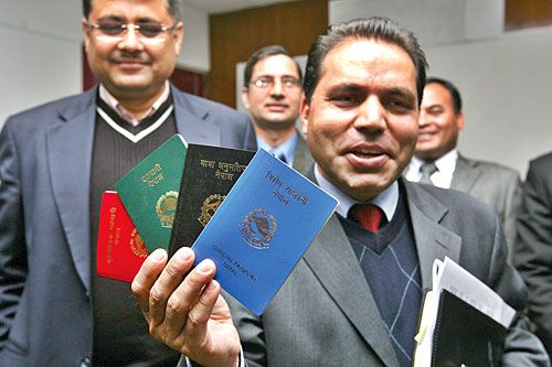 HI-TECH: A Ministry of Foreign Affairs official displays four categories of machine-readable passports at a function organised Sunday. The ministry will issue the passports 26 December onwards.