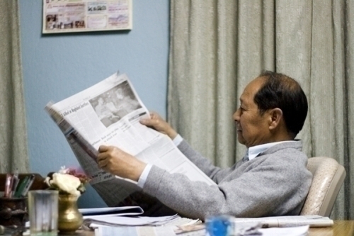 WORKING LATE: Bhaktapur constituency 1 winner Narayan Man Bijukchhe of NWPP at home on Saturday night catching up with the day's headlines.