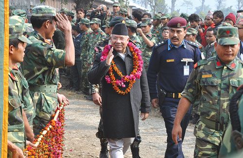 LAL SALAAM NO MORE: A Maoist ex-fighter smartly salutes Prime Minister Madhav Kumar Nepal during the handover ceremony at Shaktikhor Camp in Chitwan on Saturday.