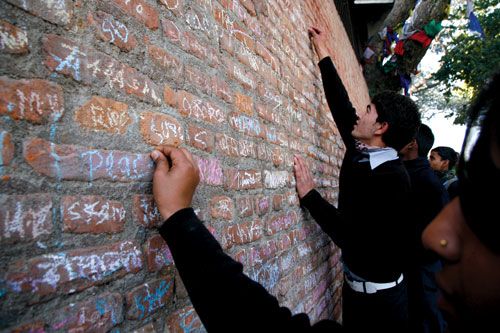 P FOR PEACE: Students write on a wall near the Saraswati Temple in Swayambhu Nath temple on Tuesday, in celebration of Shree Panchami, the festival of the goddess of knowledge, Saraswati.