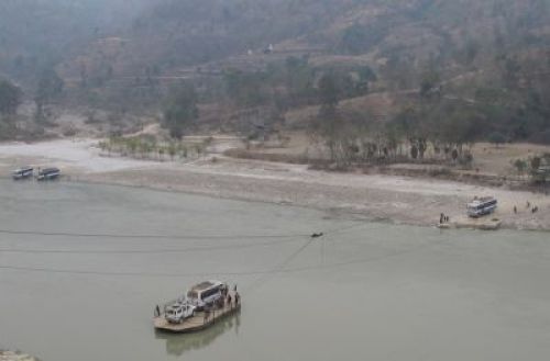 GETTING TO THE OTHER SIDE: Bus and tractors start plying again across the Arun River at Leguwa after a parallel five-day strike by a Limbuwan group and transporters was lifted on Saturday. Business and trade came to halt in nine districts east of the Arun all last week. Construction of one of two bridges across the Arun on the East-West Midhill Highway is about to start at Leguwa.