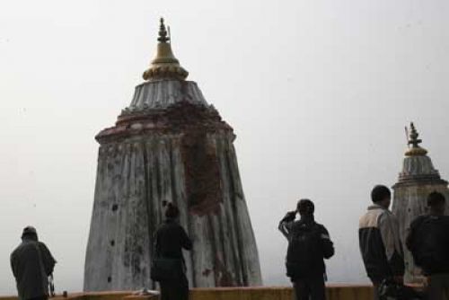 Tourists and TV journalists inspecting the damage.