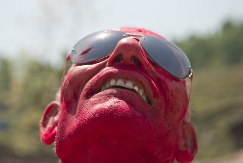 PAINT ME RED: 65-year-old Damodar Rijal from Simle enjoys himself during a celebratory rally of a Maoist win in Dhading-3.
