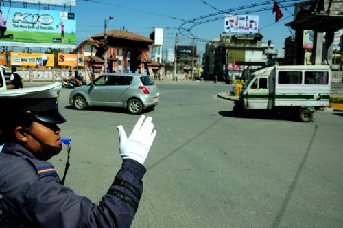 IN CHARGE: A woman traffic police officer directs vehicles at Tripureswor roundabout on Monday, a day ahead of International Women's Day.