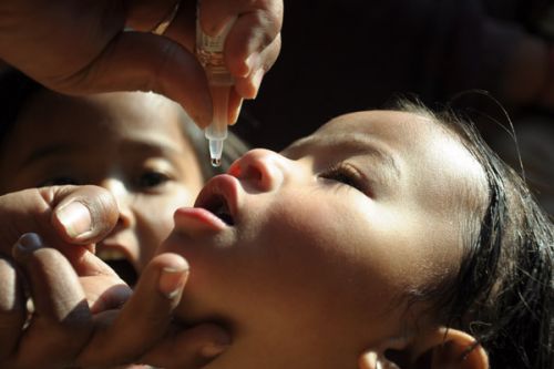 A DROP IN TIME: A young girl gets her dose of polio drops in a Polio Camp in Lalitpur on Saturday.