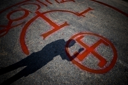 STAMP OF APPROVAL: Maoist supporters add a Swastika sign to their party symbol on the Prithvi Highway in Dhading-3. The swastika sign had been used to indicate voter's choice during the elections. Maoists have achieved sterling results, clinching 117 seat