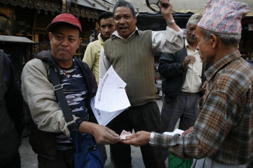CASHING IN: A man sells loadshedding schedules in New Road, Kathmandu, on Monday. The loadshedding hours have been decreased in view of the on-going SLC examination.