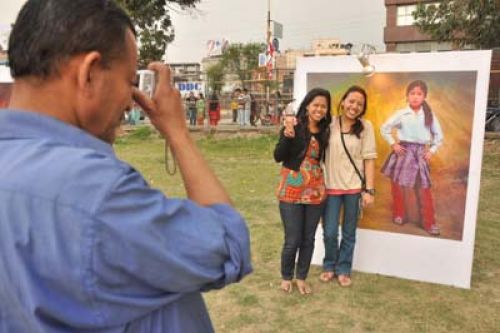 PICTURE PERFECT: Girls posing beside a photograph at the event Brick to Brick, Saturday.