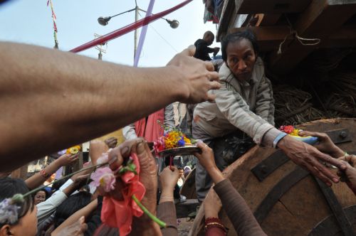 MOVING GOD: Devotees offering flowers to Seto Machhendranath as the chariot carrying the deity stops for a puja at Ason, Monday. The chariot is pulled through the lanes of Kathmandu for four days starting from Chaite Dasain.