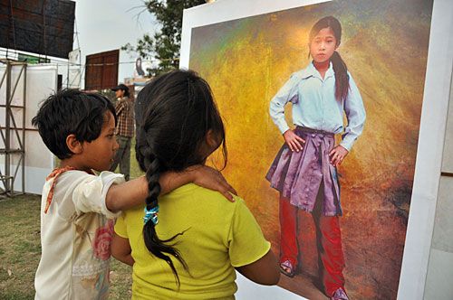 THROUGH THEIR EYES: Children examine photos of brick workers during the 'Brick by Brick' event held at Jawalakhel last Saturday.