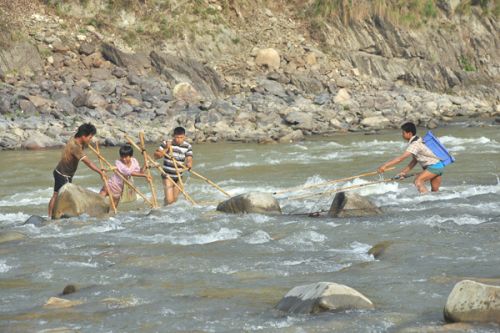 BIG SHOCK: Local fishermen catch fish through electrified rods at Kurintar on Saturday.
