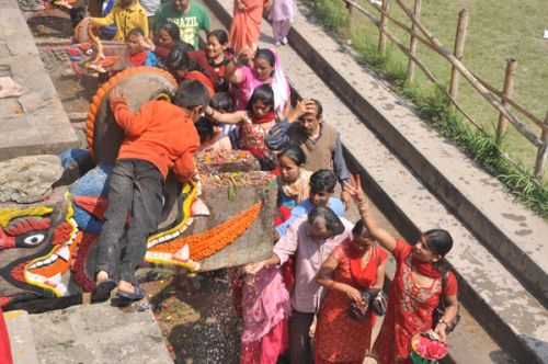 HOLY SHOWER: Devotees at 22 dhara in Balaju Park, Kathmandu, on Monday. It is believed that the water from these stone spouts, which is collected from a catchment area of Nagarjun forest, will ease pain and cure skin diseases.