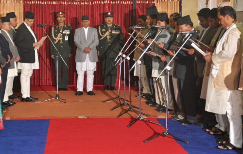 FULL HOUSE: The 14 newly appointed ministers being sworn in by Prime Minister Jhal Nath Khanal in the presence of President Ram Baran Yadav at Shital Niwas on Wednesday evening.