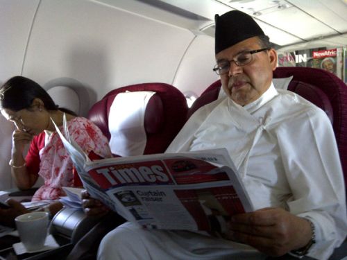 MOVING WITH THE TIMES: Prime Minister Jhal Nath Khanal catches up with news from home after takeoff from Doha on his way back from Istanbul on Thursday morning. Khanal cut short his visit to the conference of Least Developed Countries because of the political crisis in Kathmandu.