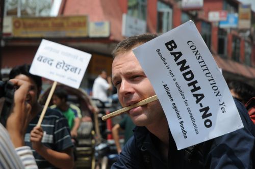 LISTEN TO US: A tourist holds a playcard protesting Friday's banda during a cycle rally organised by The Alliance Against Banda from Thamel.