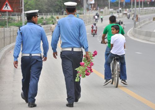 FINALLY FREE: With the usually busy road at Tinkune, Kathmandu, empty because of the banda of Friday, traffic policemen enjoy a day off.
