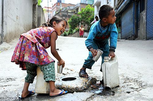 WATERHOLE: Kids fill water from a leaking pipe in Kuleshwor, Kathmandu, on Sunday.