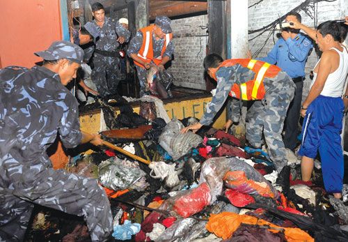 BURNT: The local police examine the salvaged goods at a garment store in Narsingh Chowk, Thamel, where a fire broke out Wednesday evening.
