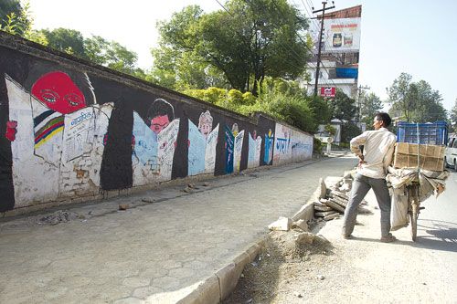 WHATCHA READING: A local observes the street art on the walls of Hotel Himalaya on Sunday morning. This is part of Artudio and Imageschool's initiative to create street art on empty walls of the city.